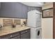 Efficient laundry area with stacked washer and dryer, countertop space, and cabinet storage at 4550 Pinebrook Cir # 505, Bradenton, FL 34209