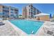 Inviting community pool area with lounge chairs and clear water, surrounded by condos at 4550 Pinebrook Cir # 505, Bradenton, FL 34209
