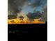Beautiful sunset with dramatic clouds over the distant neighborhood skyline from behind a screened window at 4550 Pinebrook Cir # 505, Bradenton, FL 34209