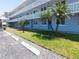 Light blue building with covered parking and palm trees in a well-maintained visitor parking area at 4715 Bay Ne St # 119, St Petersburg, FL 33703