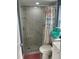 Updated bath with a marble-look tile shower, river rock floor, and printed shower curtain at 5830 Portsmouth Dr, Tampa, FL 33615
