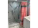 Updated bathroom showcasing a glass enclosed shower with marble style tile and river rock floor at 5830 Portsmouth Dr, Tampa, FL 33615