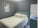 Guest bedroom featuring a full bed with a decorative throw pillow and a light wood-look floor at 5830 Portsmouth Dr, Tampa, FL 33615
