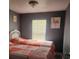 Shared bedroom with two twin beds, neutral walls, and a bright window at 5830 Portsmouth Dr, Tampa, FL 33615