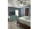 Comfortable bedroom with a wood frame bed, ceiling fan, and dresser with a flatscreen TV at 5830 Portsmouth Dr, Tampa, FL 33615