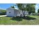 View of a manufactured home, showcasing its siding and surrounding fenced yard at 5830 Portsmouth Dr, Tampa, FL 33615