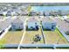 Aerial view of a home featuring a large fenced backyard and a neighborhood lake nearby at 636 Sunlit Coral St, Ruskin, FL 33570