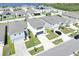 Aerial view of a neighborhood featuring neatly arranged homes, manicured lawns, and community lake at 636 Sunlit Coral St, Ruskin, FL 33570