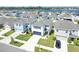Aerial view of a well-maintained home with landscaping, a driveway, and a manicured lawn at 636 Sunlit Coral St, Ruskin, FL 33570