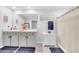 Well-lit bathroom with a double vanity, neutral colors, and ample storage space at 636 Sunlit Coral St, Ruskin, FL 33570