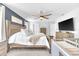 Bedroom with rustic wood bed, blue accent wall, ceiling fan, and television at 636 Sunlit Coral St, Ruskin, FL 33570