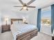 Comfortable bedroom with a patterned bedspread, bedside tables and bright natural light at 636 Sunlit Coral St, Ruskin, FL 33570