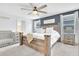 Bedroom with a rustic wood bed frame, a neutral color scheme, and soft, natural light at 636 Sunlit Coral St, Ruskin, FL 33570