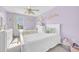 Charming bedroom featuring two twin beds, complemented by a modern ceiling fan and natural light at 636 Sunlit Coral St, Ruskin, FL 33570