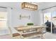Dining area with a large wooden table, bench seating, and sliding glass doors leading to the backyard at 636 Sunlit Coral St, Ruskin, FL 33570