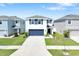 Charming two-story home featuring a well-manicured lawn, two-car garage, and classic architectural details at 636 Sunlit Coral St, Ruskin, FL 33570