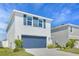 Charming home with a blue two-car garage, complemented by manicured landscaping and a bright, welcoming exterior at 636 Sunlit Coral St, Ruskin, FL 33570