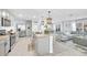 Modern kitchen with an island, stainless-steel appliances, and open layout to the living area at 636 Sunlit Coral St, Ruskin, FL 33570