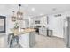 Modern kitchen boasts stainless appliances, gray cabinets, granite counters, and large island at 636 Sunlit Coral St, Ruskin, FL 33570