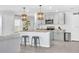 Open kitchen with a spacious island, pendant lighting, modern appliances, and light-gray cabinetry at 636 Sunlit Coral St, Ruskin, FL 33570