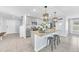 Open concept kitchen with a center island, pendant lighting, and stainless-steel appliances at 636 Sunlit Coral St, Ruskin, FL 33570