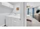 Convenient laundry room with appliances next to a bedroom with a ceiling fan at 636 Sunlit Coral St, Ruskin, FL 33570