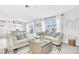 Comfortable living room features a large sectional sofa, ottoman, and natural light at 636 Sunlit Coral St, Ruskin, FL 33570