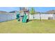 Backyard featuring a wooden playset with a slide and swings, perfect for outdoor fun at 636 Sunlit Coral St, Ruskin, FL 33570