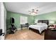 Well-lit bedroom with tile flooring, a ceiling fan, and a charming desk area at 7111 13Th E St, Sarasota, FL 34243