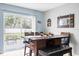 Cozy dining area next to a sliding door with a view of a lush backyard and outdoor seating at 7111 13Th E St, Sarasota, FL 34243