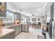 Open kitchen with light gray cabinets, stainless steel appliances, tile flooring, and a dining area at 7111 13Th E St, Sarasota, FL 34243