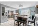 Modern kitchen featuring an island, dining table, stainless steel appliances, and access to the backyard at 7111 13Th E St, Sarasota, FL 34243