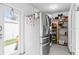 Pantry featuring stainless steel refrigerator, ample storage and access to the backyard at 7111 13Th E St, Sarasota, FL 34243