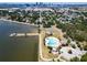 A stunning aerial view highlighting a community pool, park, and waterfront access with the city skyline in the distance at 718 S 22Nd St, Tampa, FL 33605