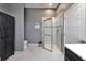 Bathroom with a tiled shower, a dark wood cabinet, and marble tile floors at 718 S 22Nd St, Tampa, FL 33605