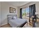 Comfortable bedroom with natural light, window, and hardwood floors at 718 S 22Nd St, Tampa, FL 33605