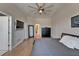 Cozy bedroom featuring a ceiling fan, wood floors, and a mirror for a stylish space at 718 S 22Nd St, Tampa, FL 33605
