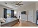 Bedroom featuring a ceiling fan, a TV, and a window with dark curtains at 718 S 22Nd St, Tampa, FL 33605