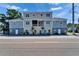 Multi-level building showcasing varying pastel colors and a balcony, sitting parallel to a paved road at 718 S 22Nd St, Tampa, FL 33605