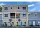 Two-story exterior features a mix of brick and neutral siding, complemented by inviting blue door at 718 S 22Nd St, Tampa, FL 33605