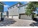 Modern townhome exterior with brick paved parking and multiple car garages at 718 S 22Nd St, Tampa, FL 33605