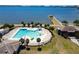 An aerial view showcasing a community pool with palm trees and a nearby building at 718 S 22Nd St, Tampa, FL 33605