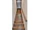 Wooden staircase with natural finish and handrail leads to the upper level of the home at 718 S 22Nd St, Tampa, FL 33605