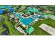 Stunning aerial view of community amenities with pools, clubhouse, tennis courts, and lush green landscaping at 8125 Stone Path Way, Tampa, FL 33647