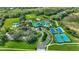 Stunning aerial view of community amenities, including pools, tennis courts, and lush green spaces at 8125 Stone Path Way, Tampa, FL 33647