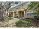 Spacious backyard with a covered patio, green grass, and mature shade trees at 8125 Stone Path Way, Tampa, FL 33647