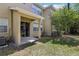 Property backyard showing covered patio with sliding glass door and green grass at 8125 Stone Path Way, Tampa, FL 33647