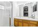 Bathroom with double vanity, wood cabinets, glass shower, and good lighting at 8125 Stone Path Way, Tampa, FL 33647