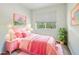 Bedroom featuring pink accents and decor with natural light from the window at 8125 Stone Path Way, Tampa, FL 33647
