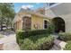 Well-kept townhome exterior with stone accents and lush green bushes at 8125 Stone Path Way, Tampa, FL 33647